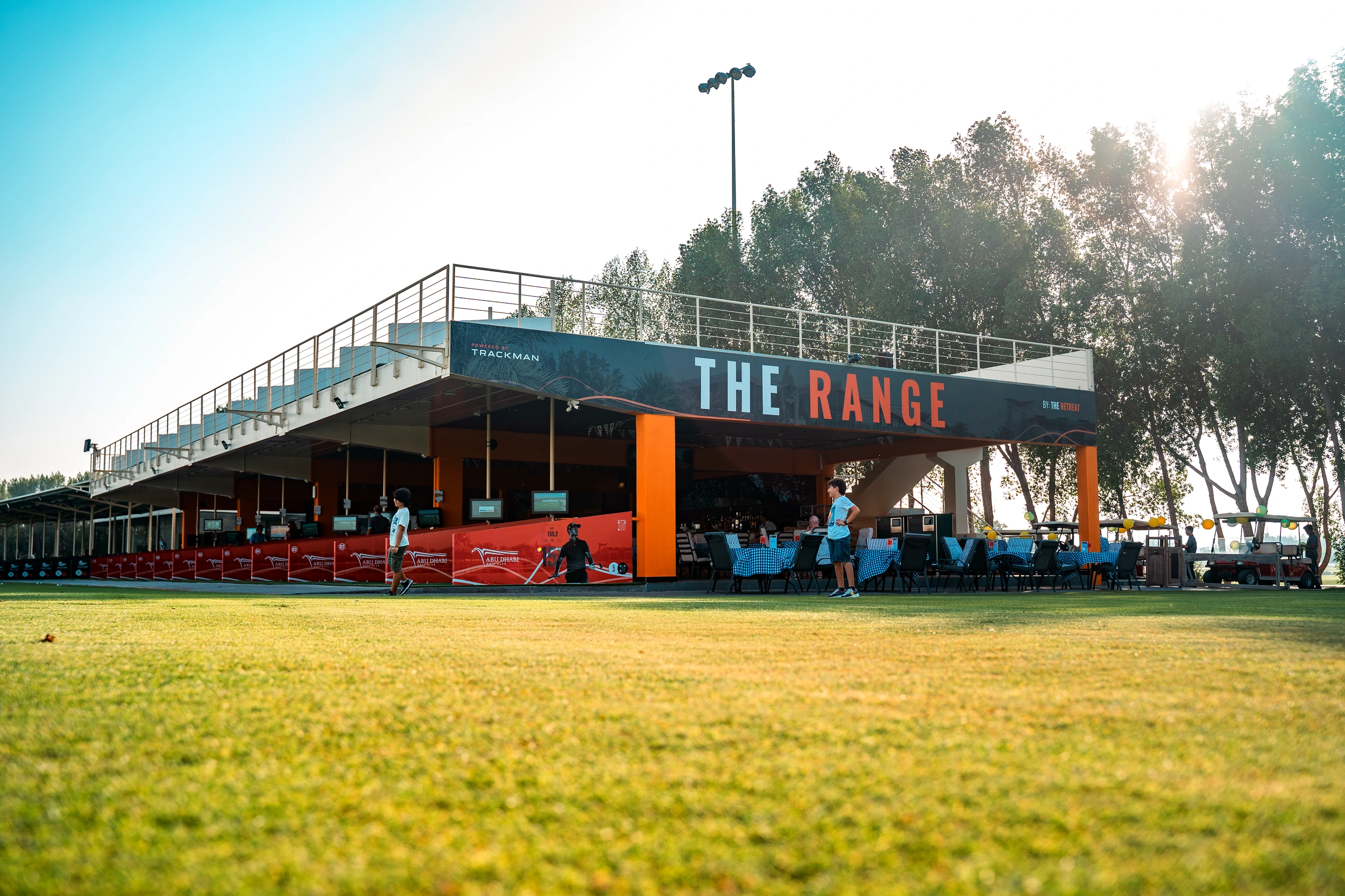 High-tech floodlit night golf practice bays equipped with TrackMan Range technology at Abu Dhabi Golf Club