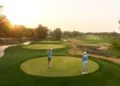 Jumeirah Golf Estates Dubai championship golf course tee shot at golden hour sunset