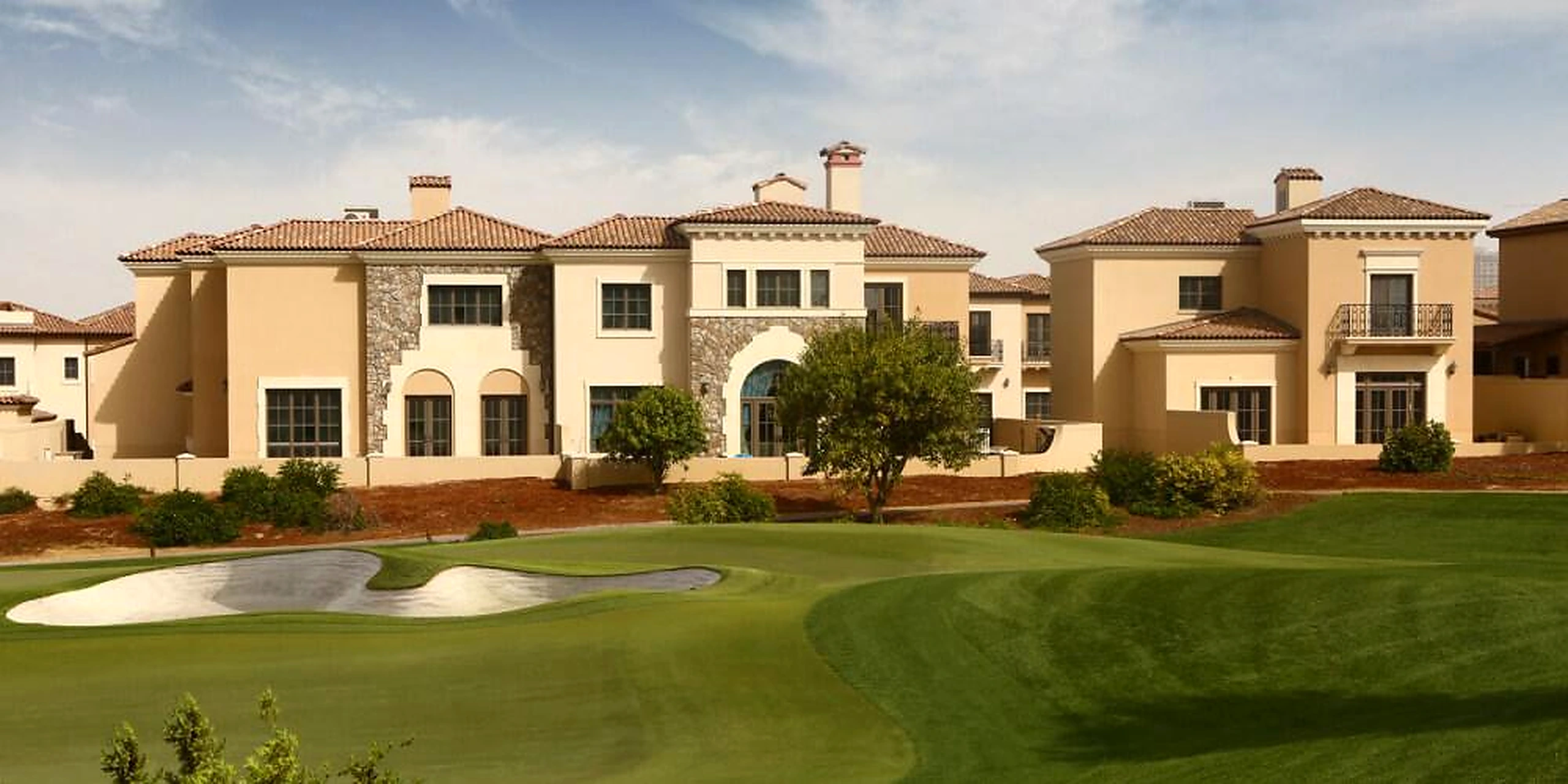 Jumeirah Golf Estates Fire Course undulating fairways and Tuscan golf estates