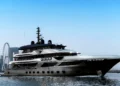 Marcus Yachting luxury crewed superyacht charter cruising past Ain Dubai and Dubai Marina skyline