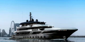 Marcus Yachting luxury crewed superyacht charter cruising past Ain Dubai and Dubai Marina skyline